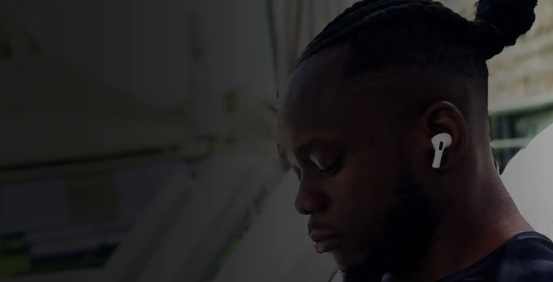 John Ozoemena with his head down, looking very focused at something